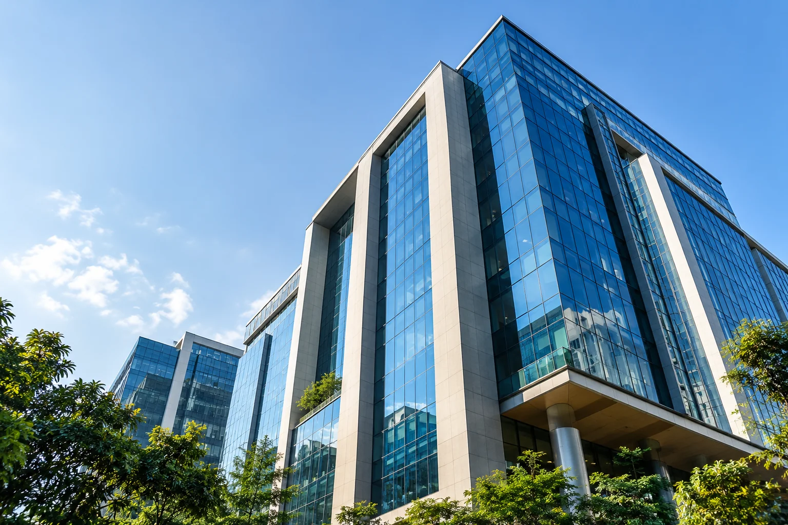 Contemporary glass building against a clear blue sky